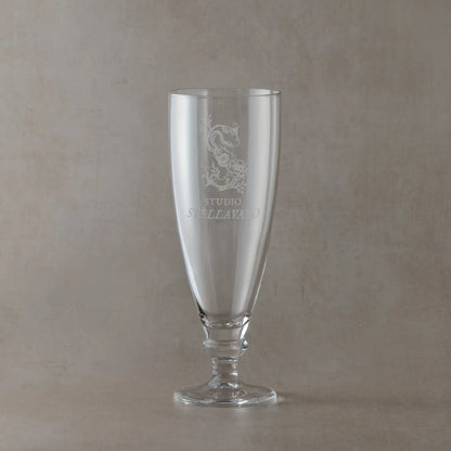 Custom corporate tapered stemmed beer glass engraved with business logo, shown on a neutral background