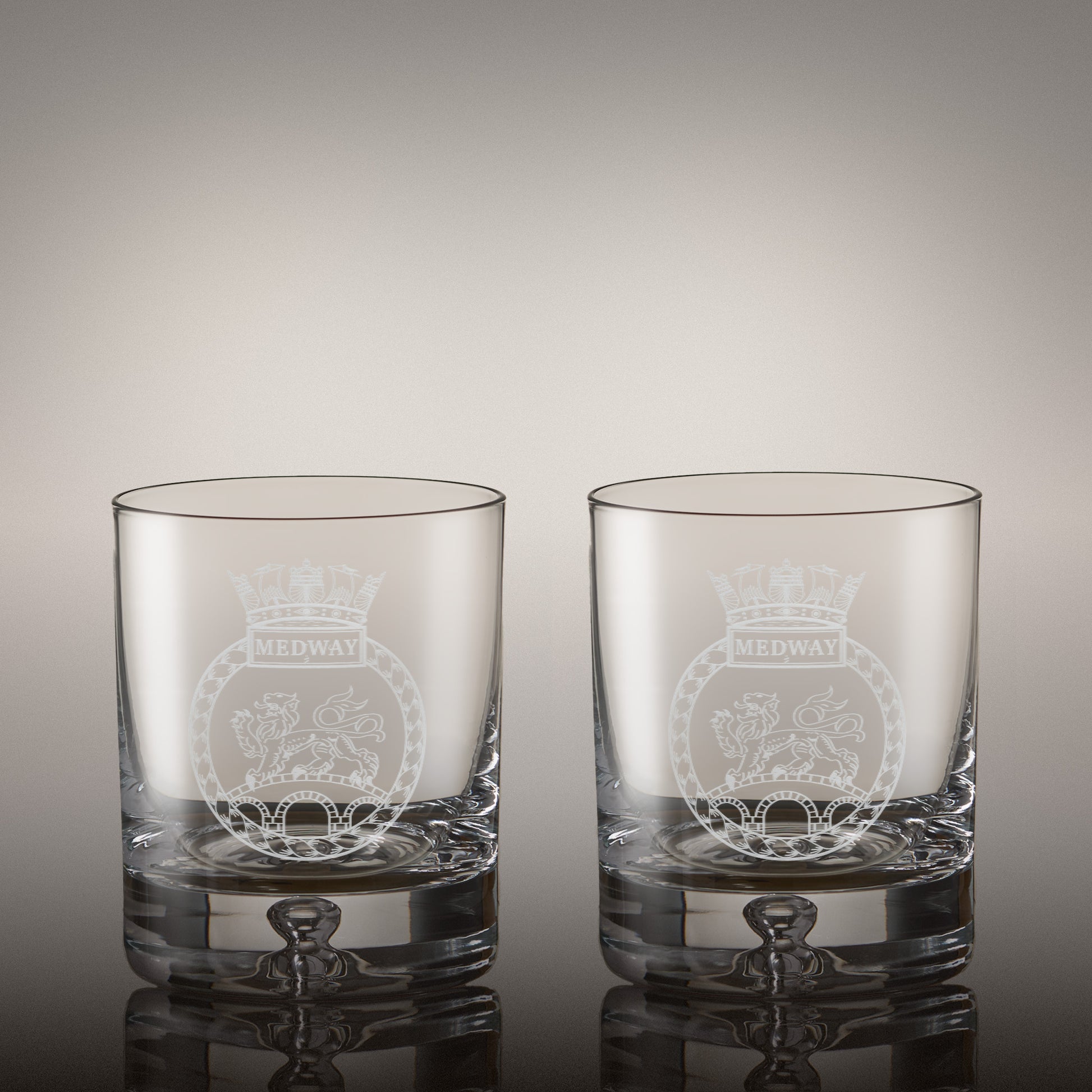 Pair of engraved whisky glasses with matching corporate logos