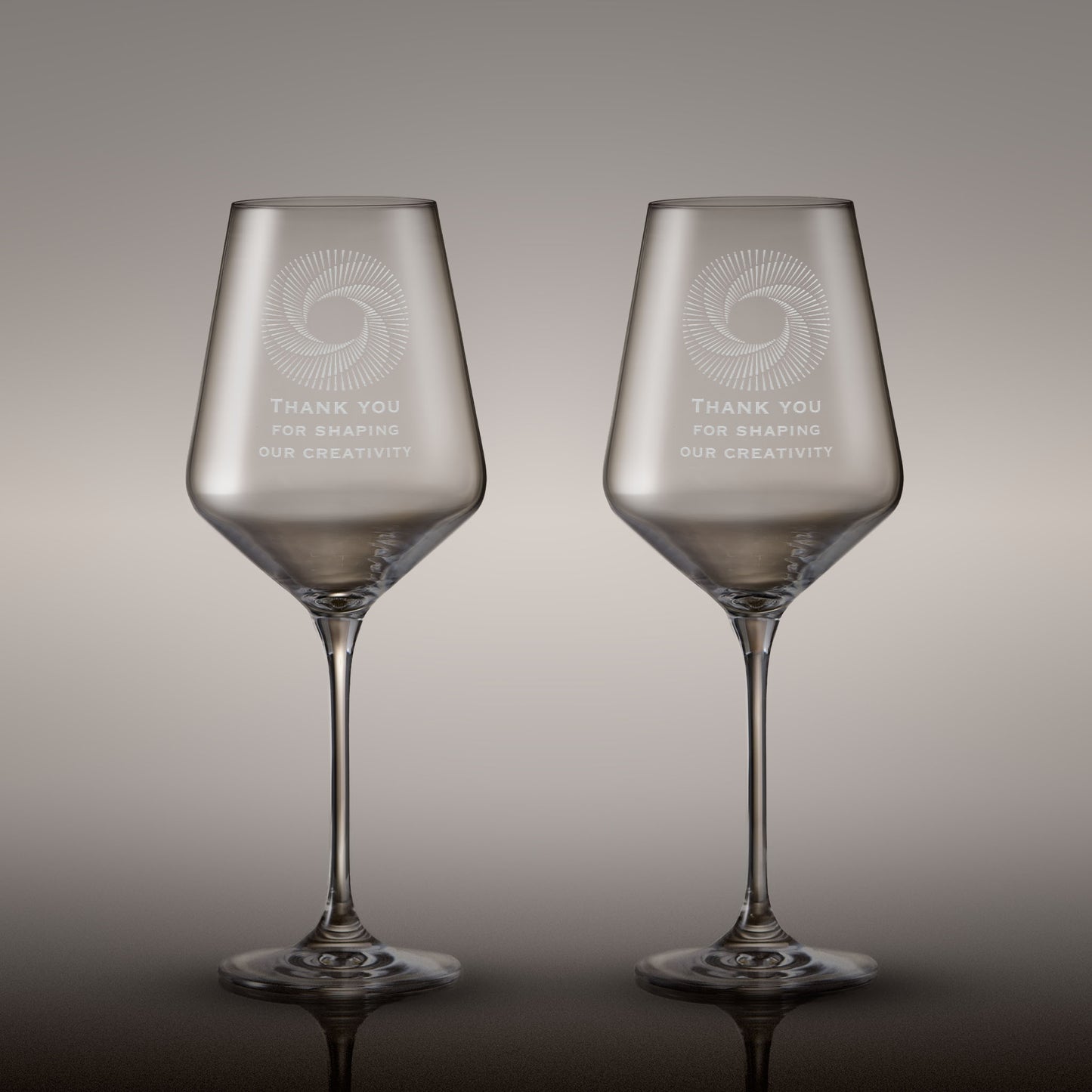 Pair of engraved wine glasses with corporate logo and inscription