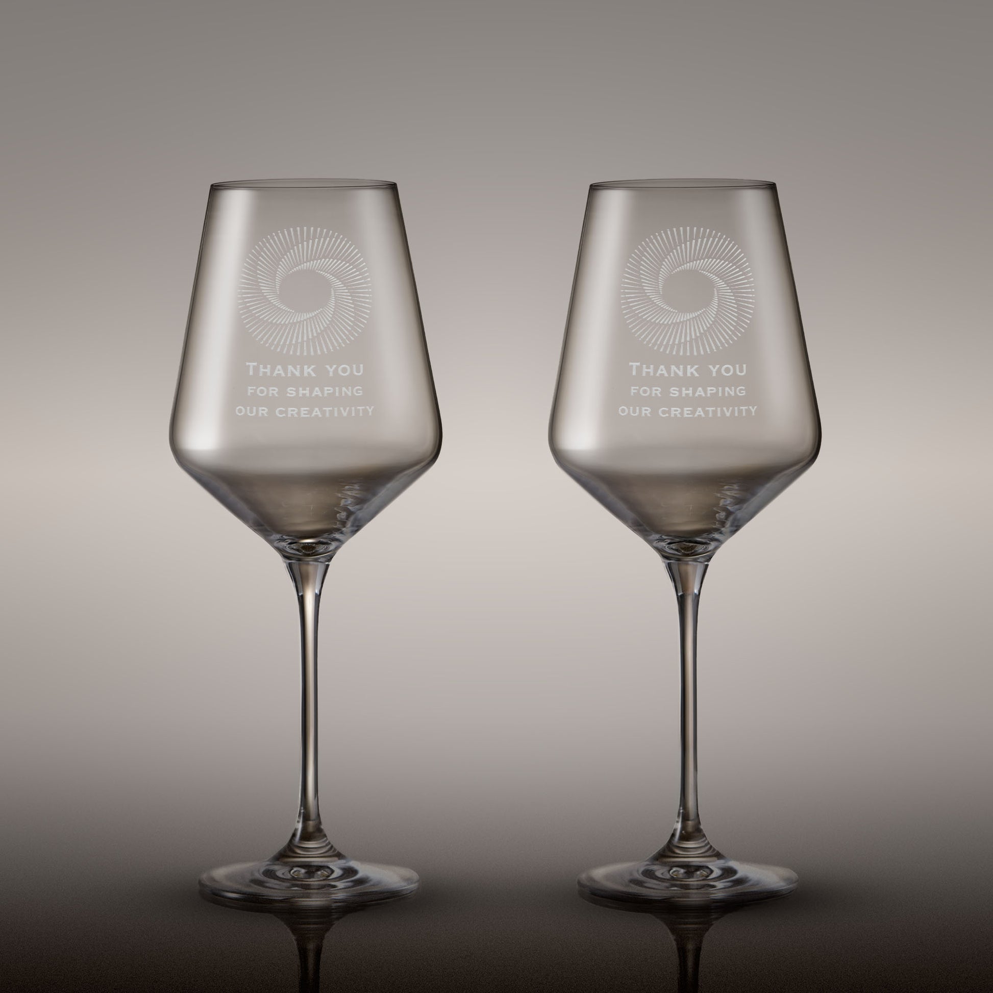 Pair of engraved wine glasses with corporate logo and inscription
