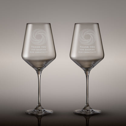 Pair of engraved wine glasses with corporate logo and inscription