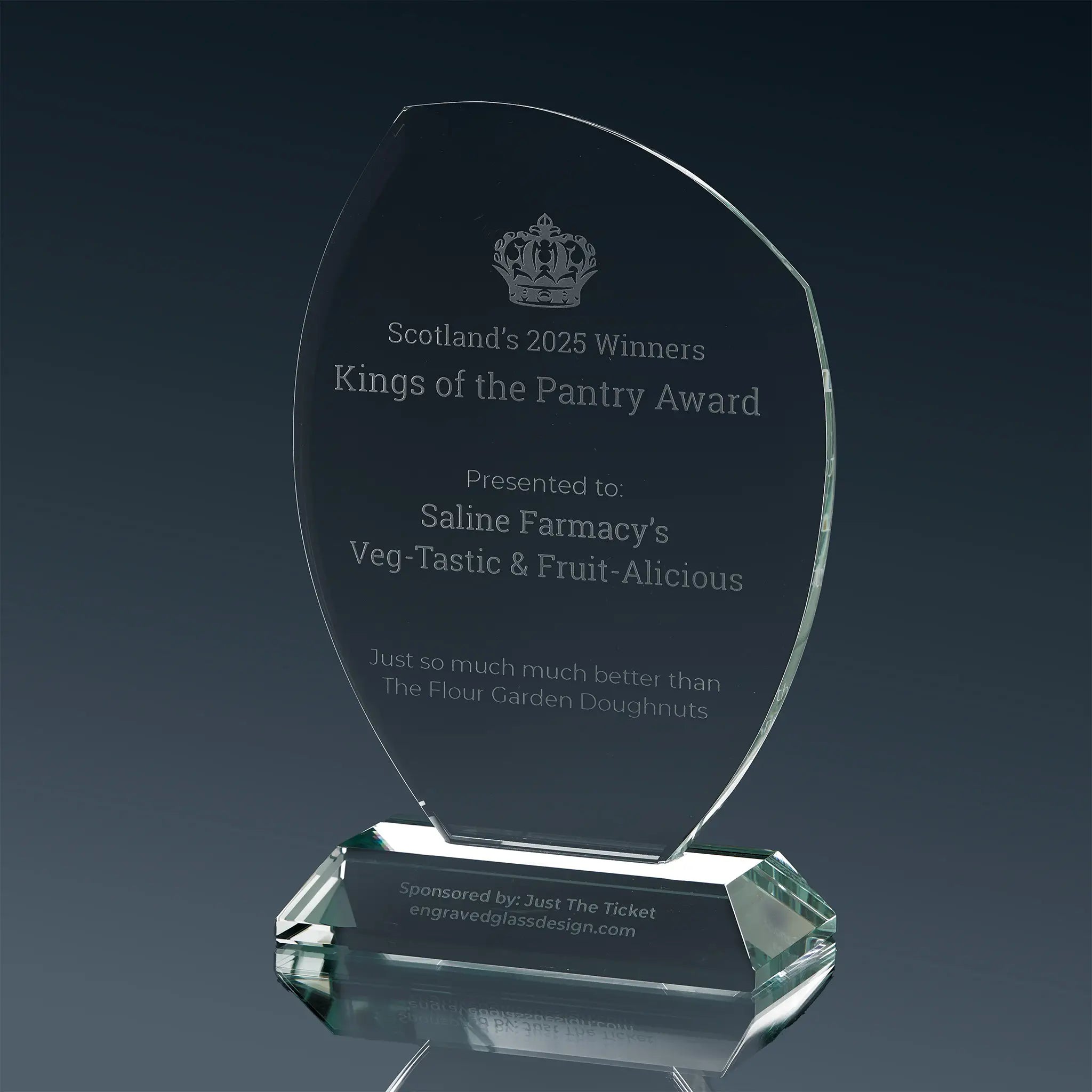 A glass trophy with logo and engraved text along with additional personalised content.
