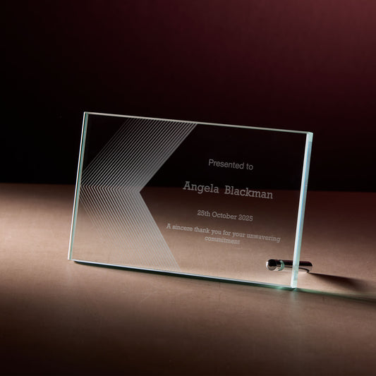 Corporate glass display plaque with engraved personalised text on a dark surface