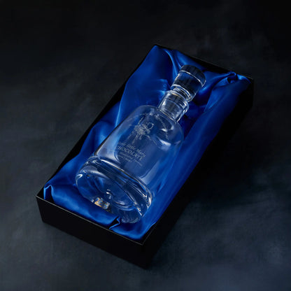 Engraved custom corporate logo spirit decanter presented in a satin-lined gift box, photographed against a deep blue background