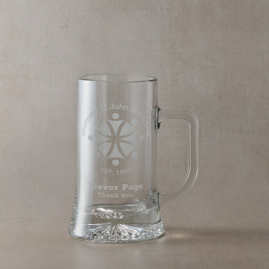Glass tankard with a corporate logo and a personalised engraved message on a white background