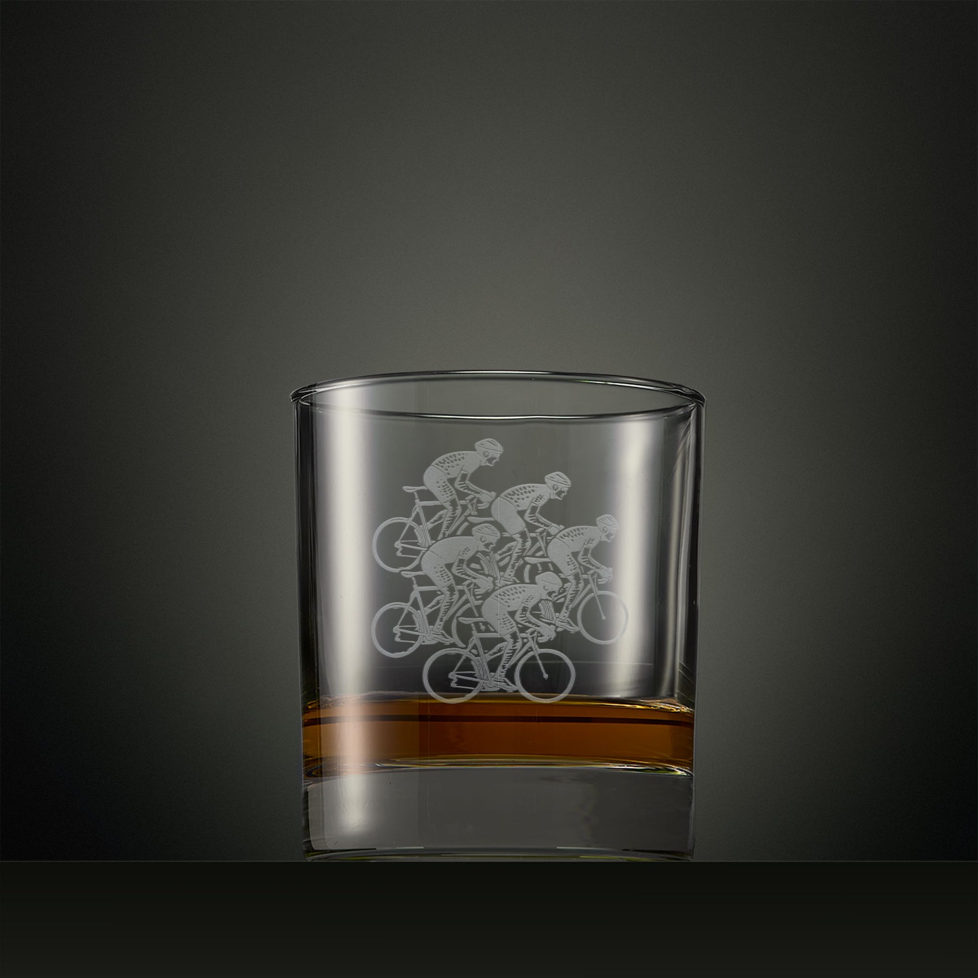 Whisky glass engraved with five cyclist silhouettes, personalised cycling gift.