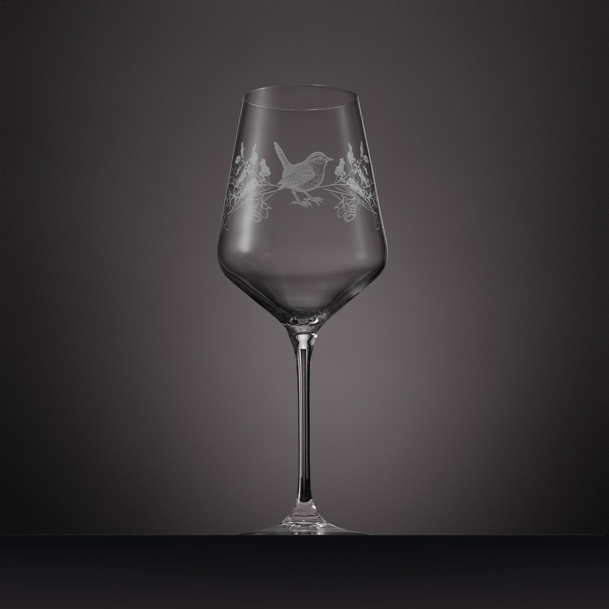 Wraparound engraving of  holly, narcissus and a wren on a wine glass