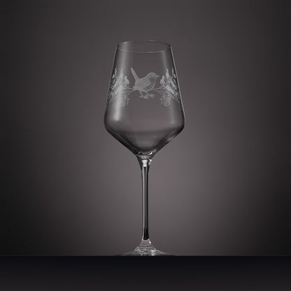 Wraparound engraving of  holly, narcissus and a wren on a wine glass