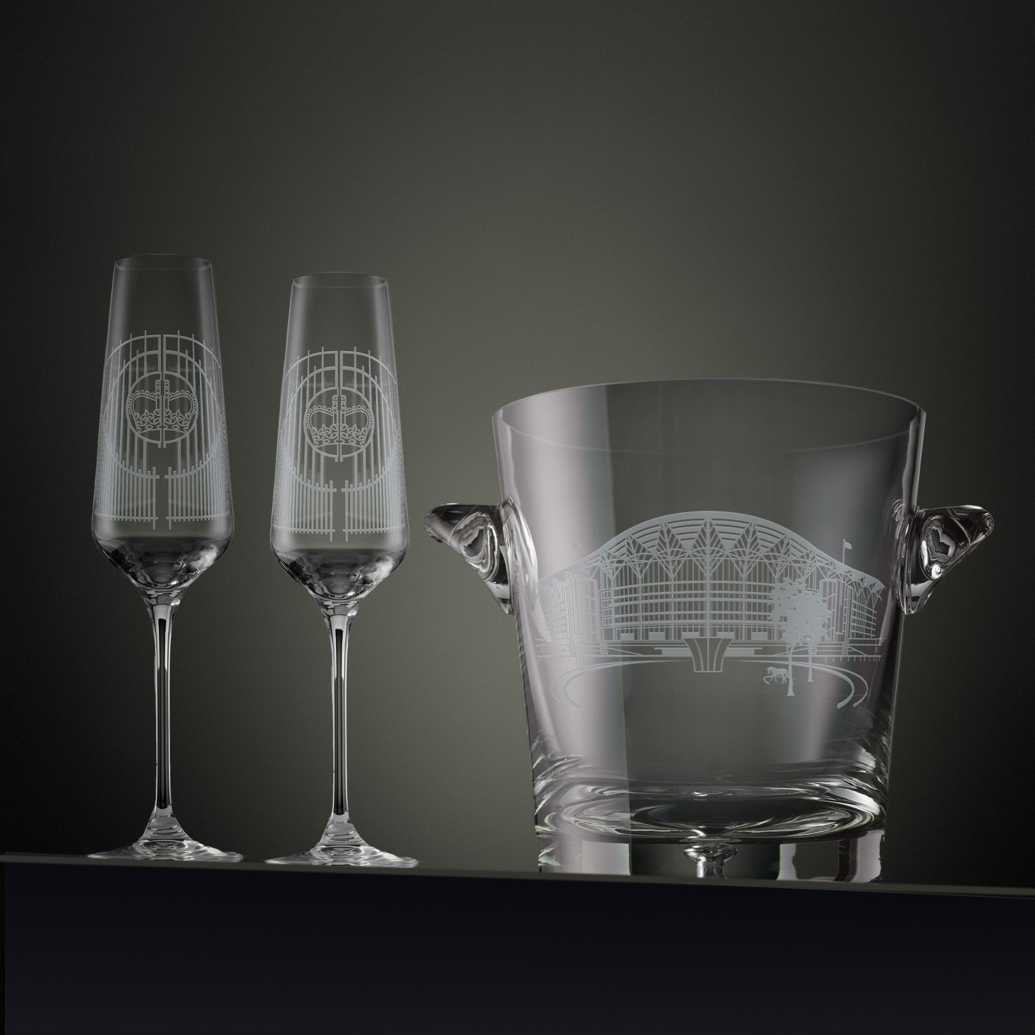 Two engraved Ascot champagne flutes and a matching ice bucket 