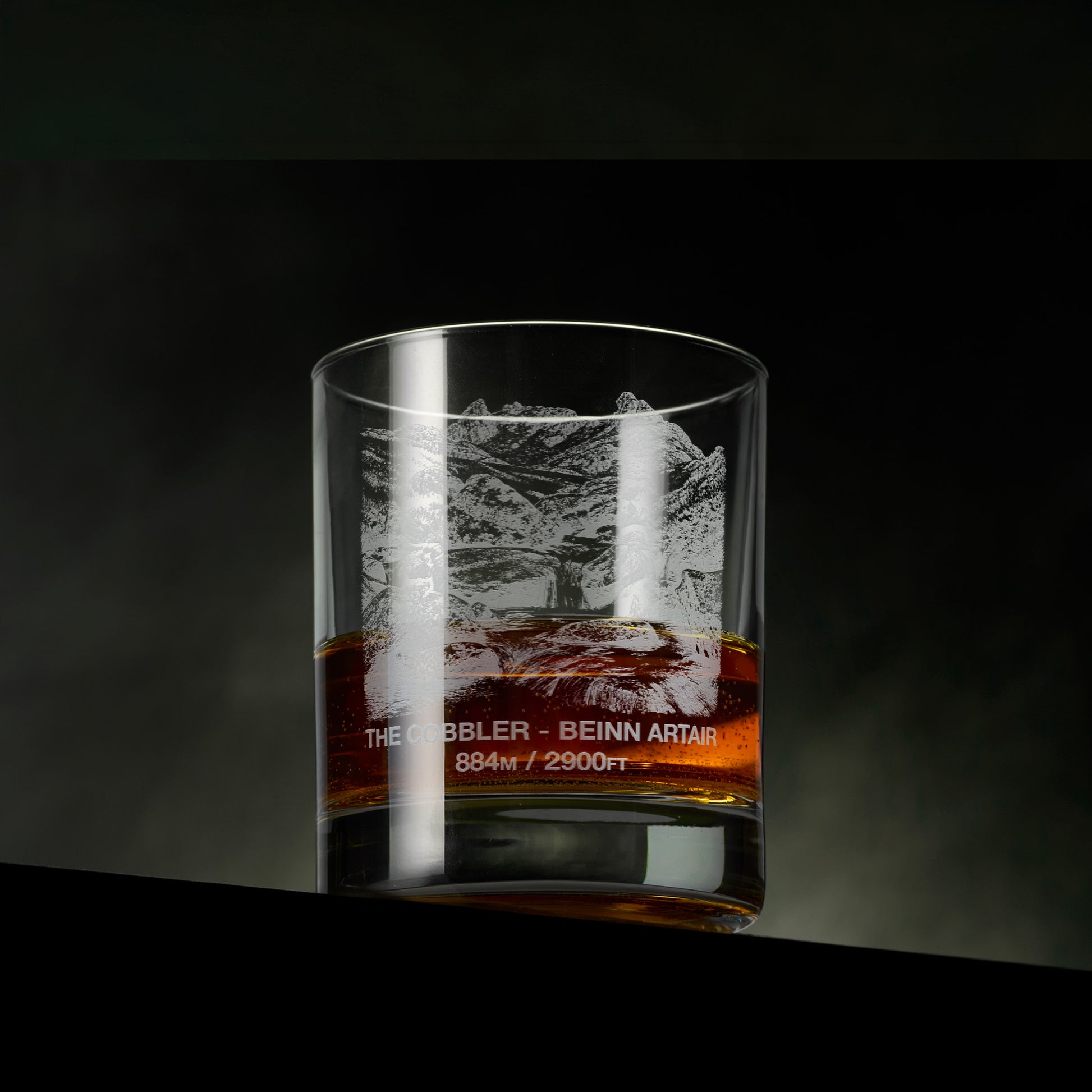 Engraved whisky glass featuring The Cobbler (Beinn Artair) with a mountain stream, rocky foreground and the distinctive twin peaks beyond.