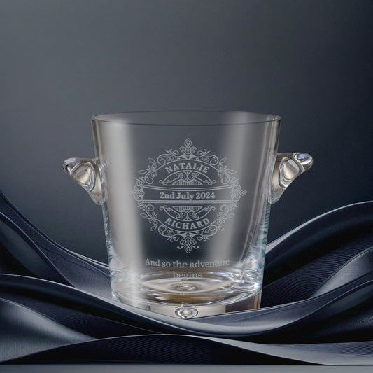 Glass champagne cooler engraved with Bride and Groom's name, date and inscription surrounded by a delicate lacework design