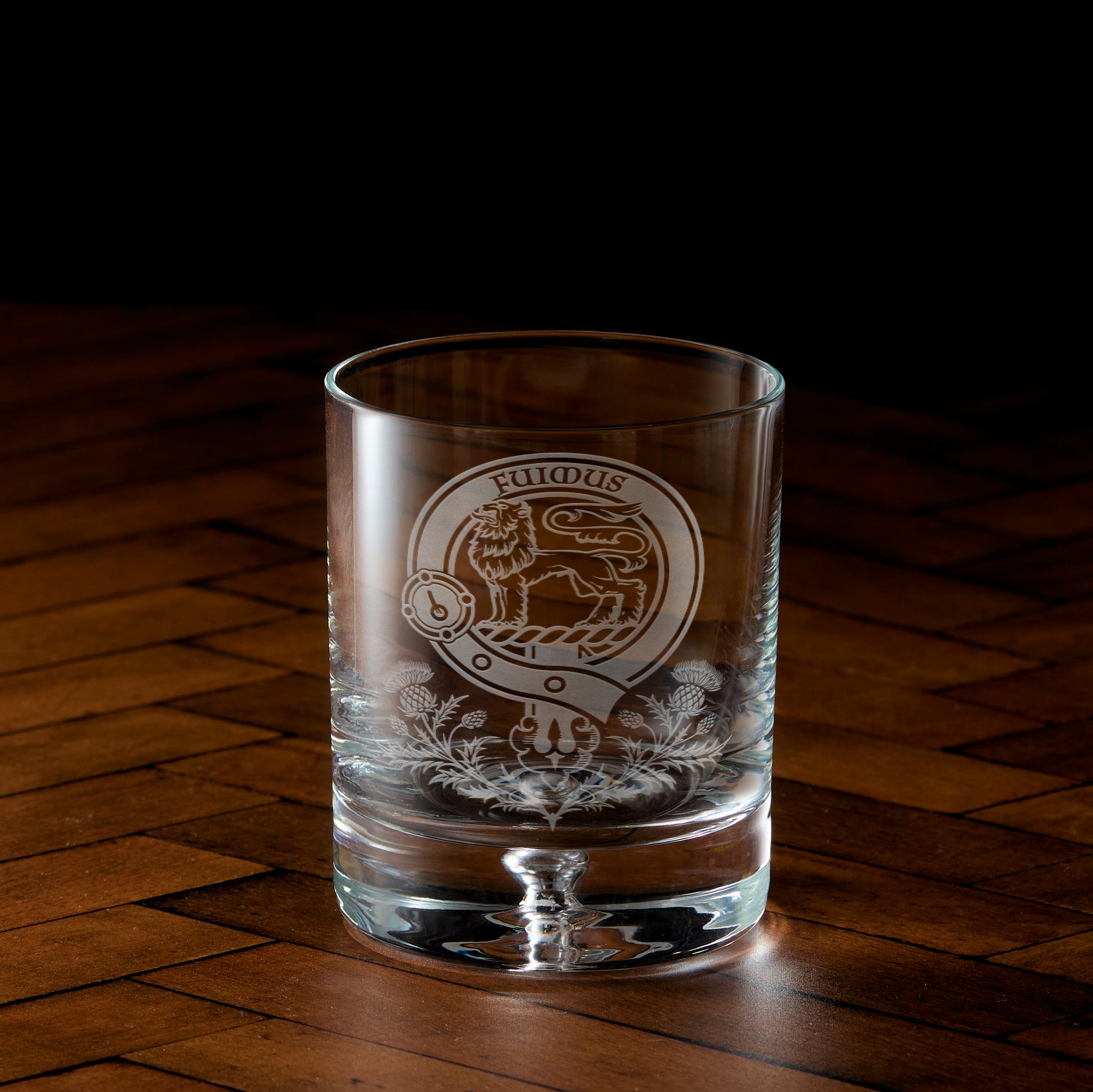 Engraved whisky glass with Scottish clan crest, belt and buckle design with thistles underneath