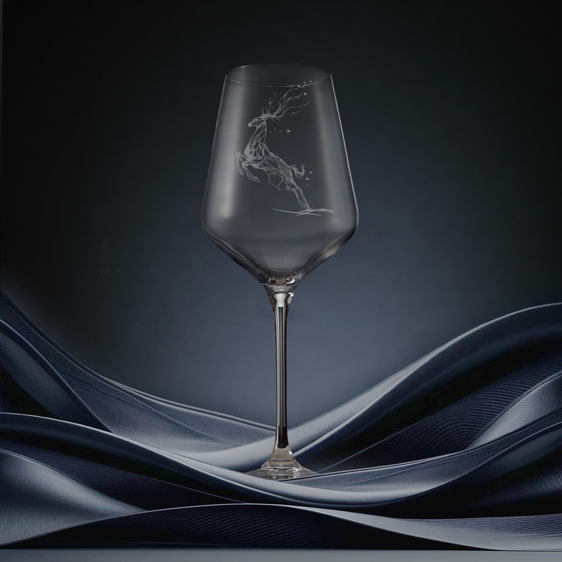 Engraved wine glass featuring a constellation design of stag leaping through stars