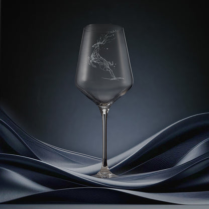 Engraved wine glass featuring a constellation design of stag leaping through stars