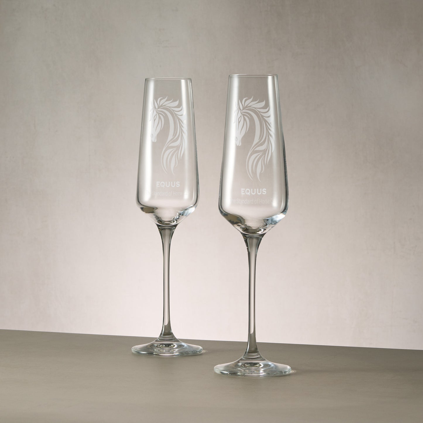 Pair of bespoke engraved champagne flutes featuring a custom corporate logo.