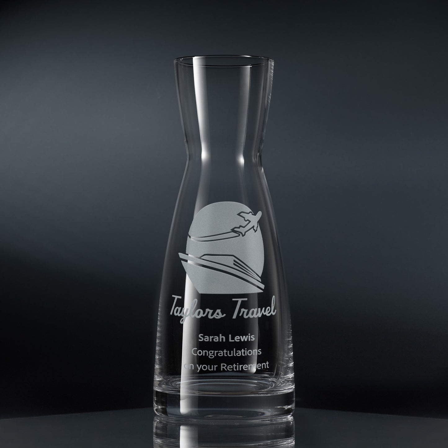 A clear glass carafe engraved with a corporate logo and personalised message