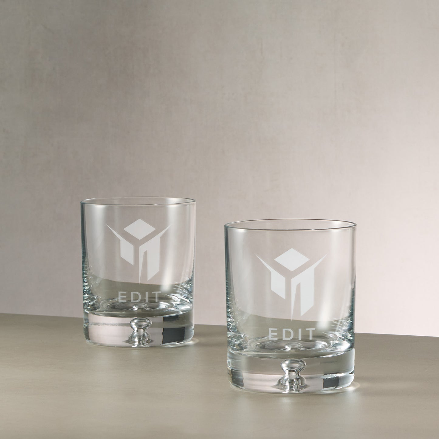 Pair of bespoke branded whisky glasses engraved with corporate logo