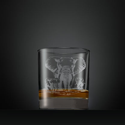 Engraved whisky glass featuring a mother elephant with two calves