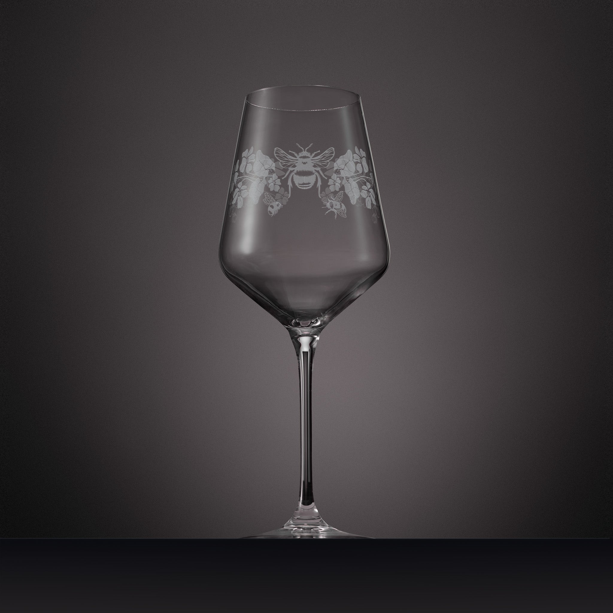 Engraved wine glass with floral design of primroses, violets and bees