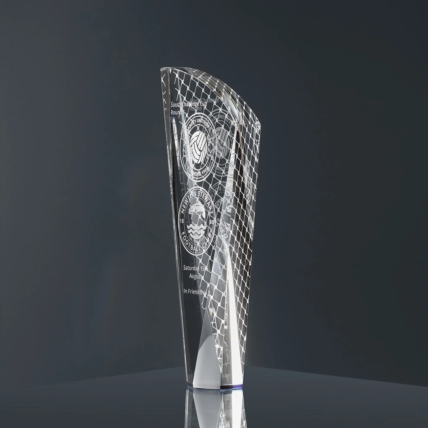 Engraved optical crystal glass shard award featuring football-themed graphics, team logos and personalised text