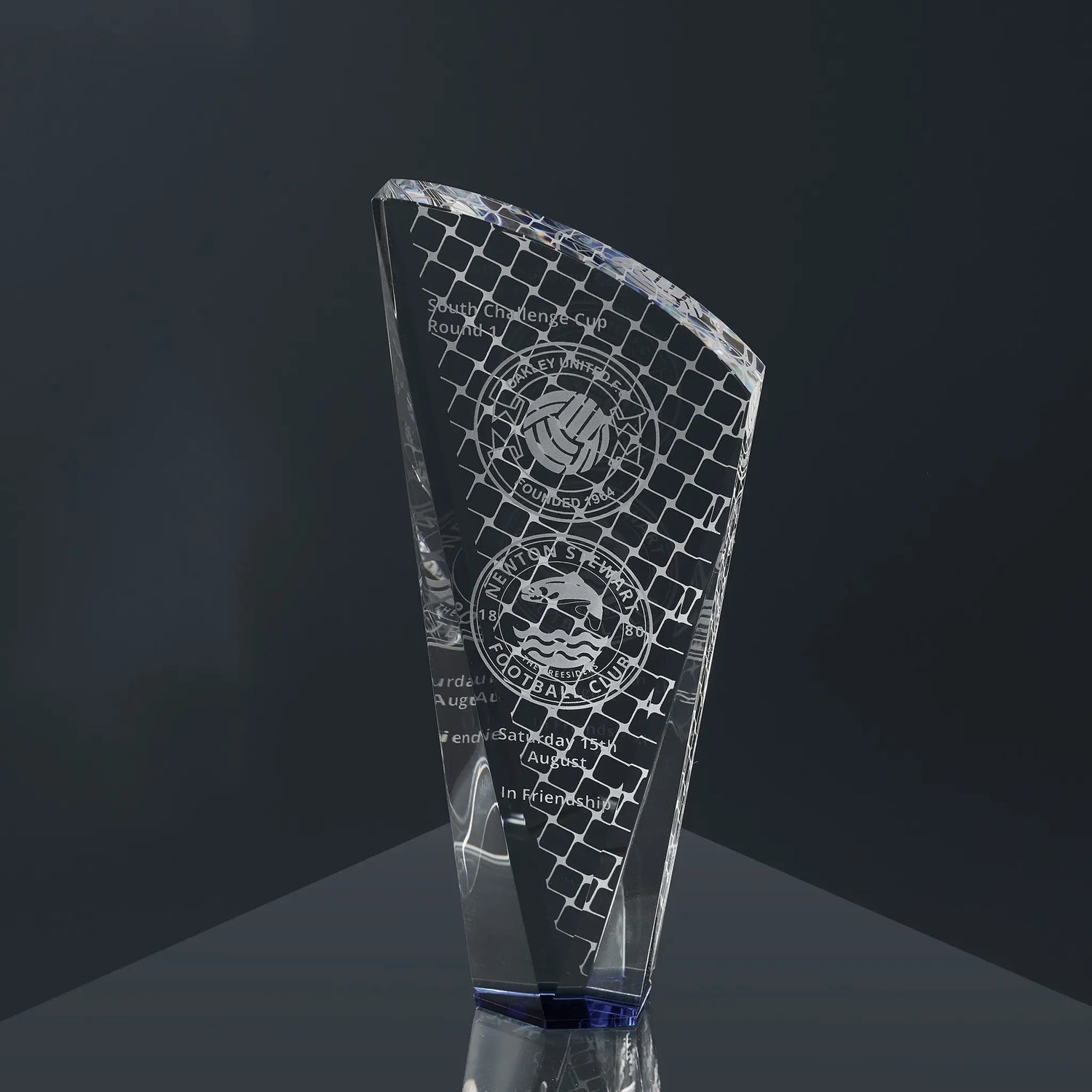 Tapered optical crystal glass award engraved with football-themed graphics, sports team logos and personalised text