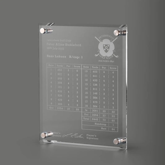 Engraved golf scorecard wall plaque with silver-toned corner brackets, featuring a golf course logo, player details, a scorecard table, and a signature line.