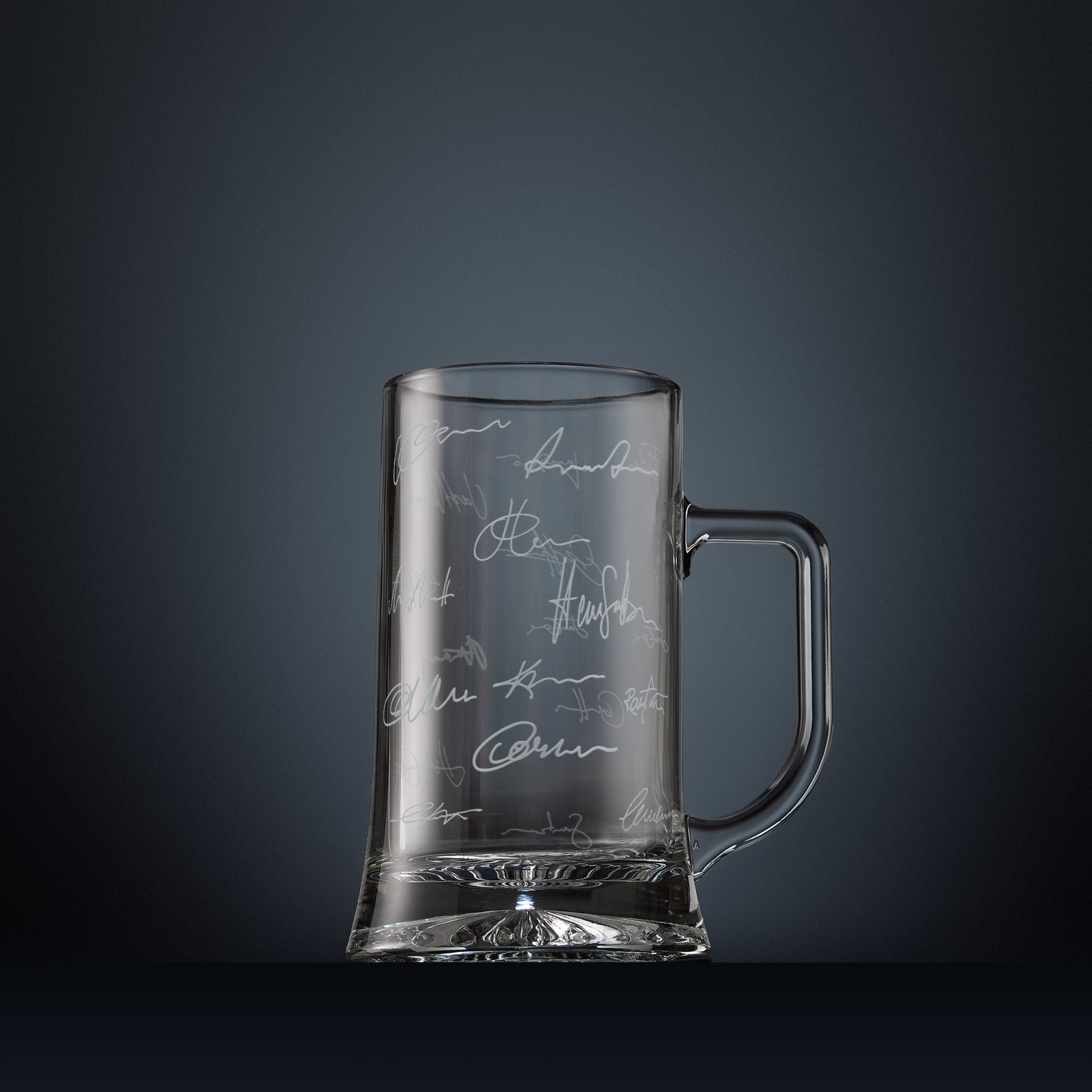 Engraved glass beer tankard with lots of handwritten signatures in a wraparound design