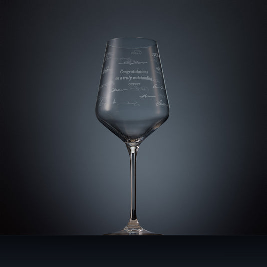 Engraved wine glass with congratulations text and handwritten signatures in a wraparound design