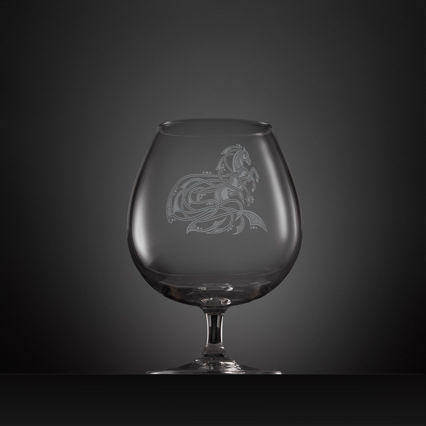 Engraved brandy glass with an  illustration of a horse entwined with Celtic knotwork