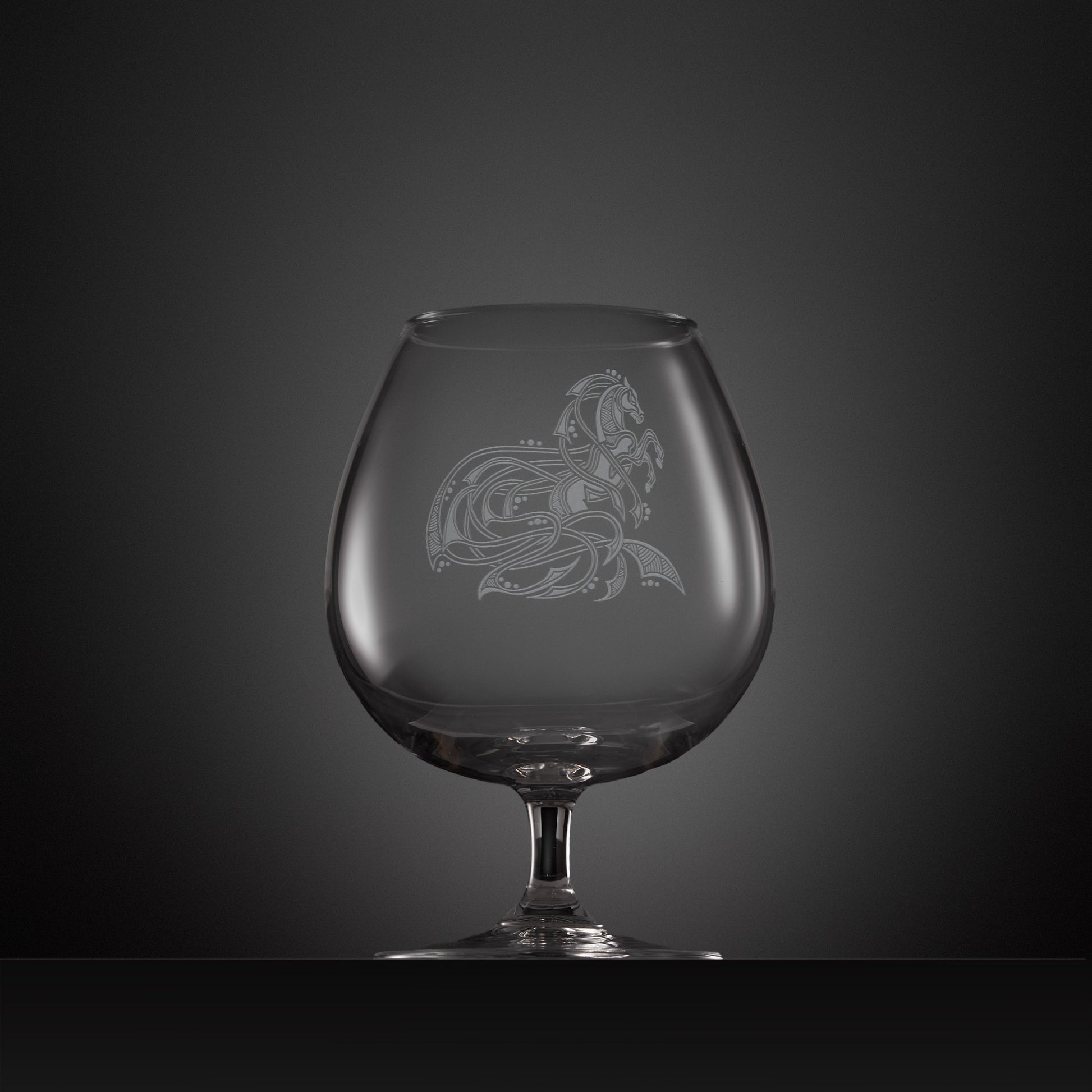 Engraved brandy glass with an  illustration of a horse entwined with Celtic knotwork