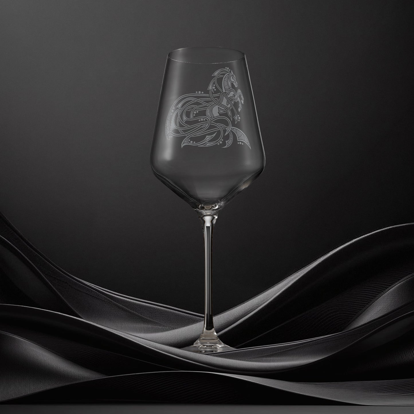 Engraved wine glass with an  illustration of a horse with flowing Celtic knotwork