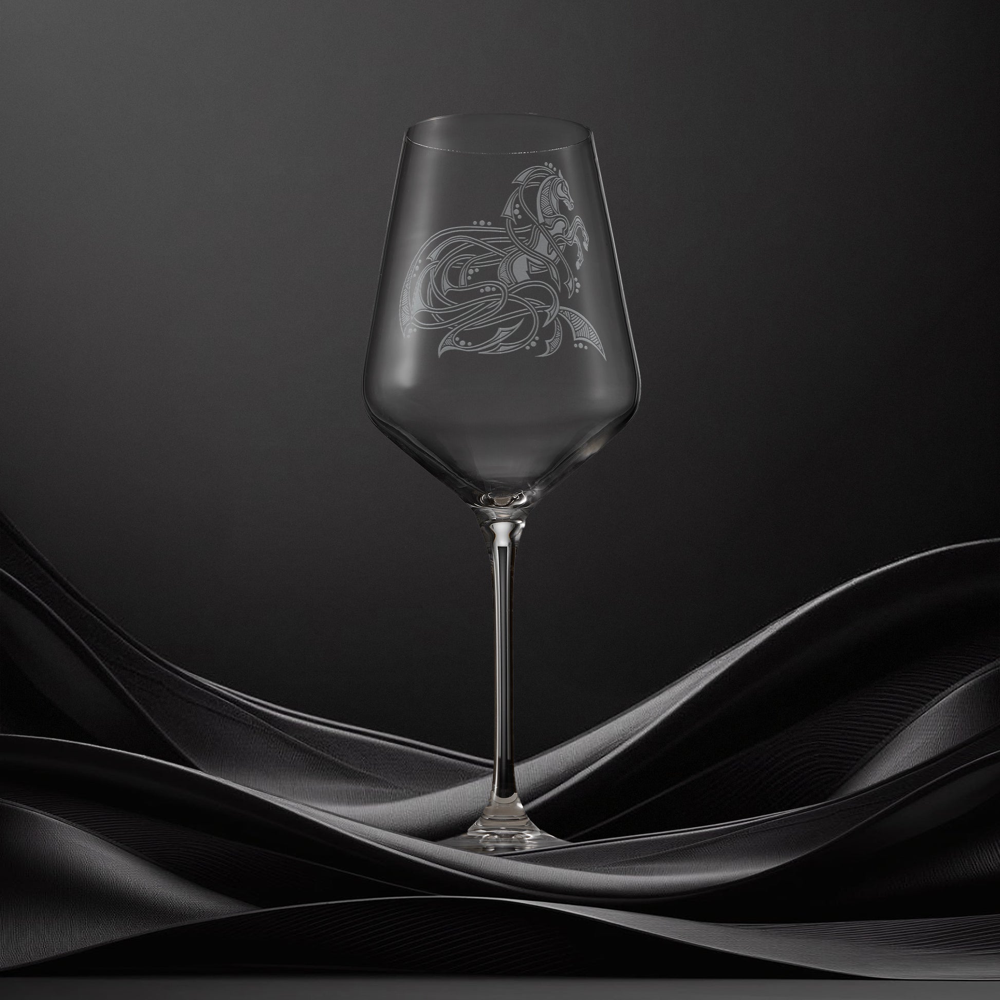 Engraved wine glass with an  illustration of a horse with flowing Celtic knotwork