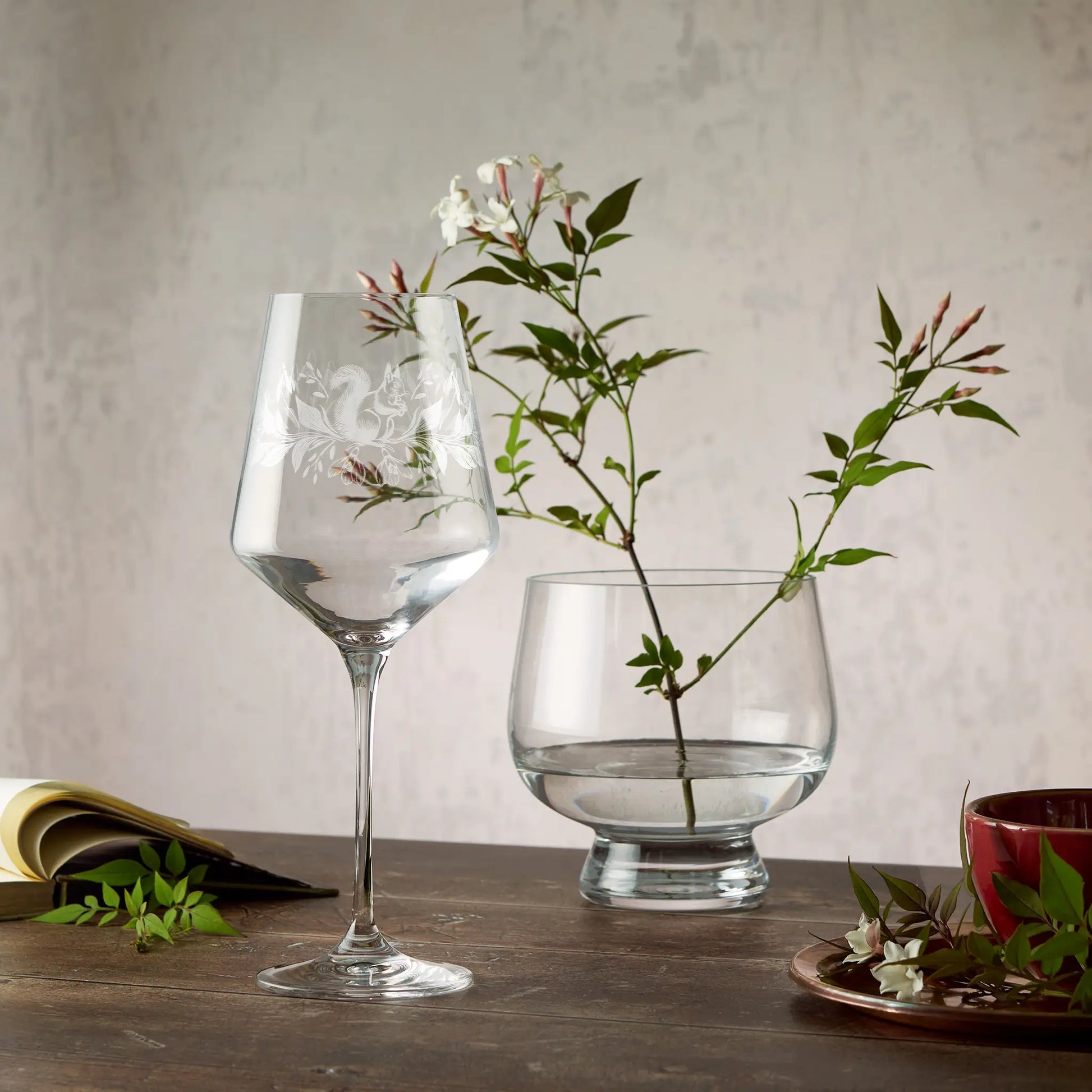 Engraved wine glass with snowdrops and red squirrel design in wraparound composition