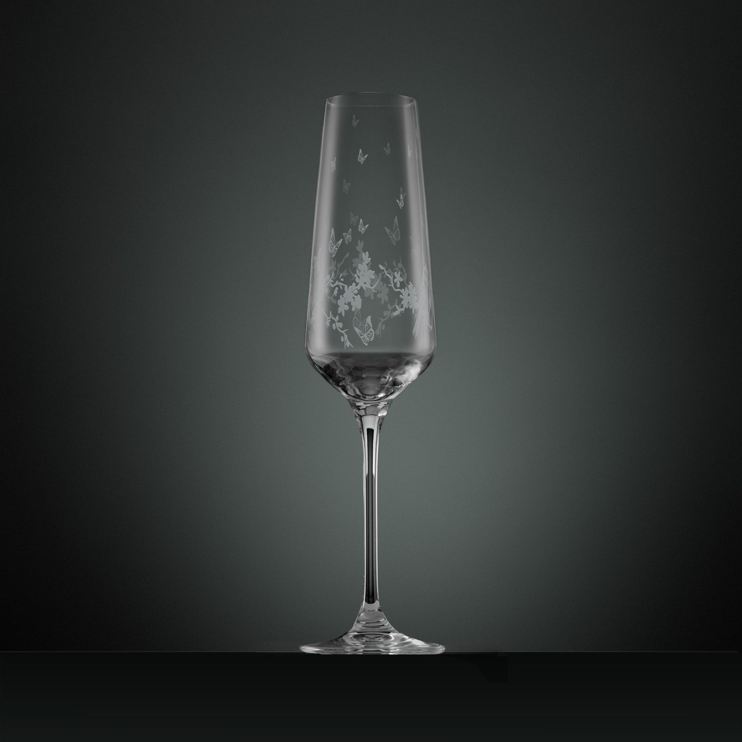 Engraved wraparound garland featuring garden birds, butterflies and blossom on a champagne flute