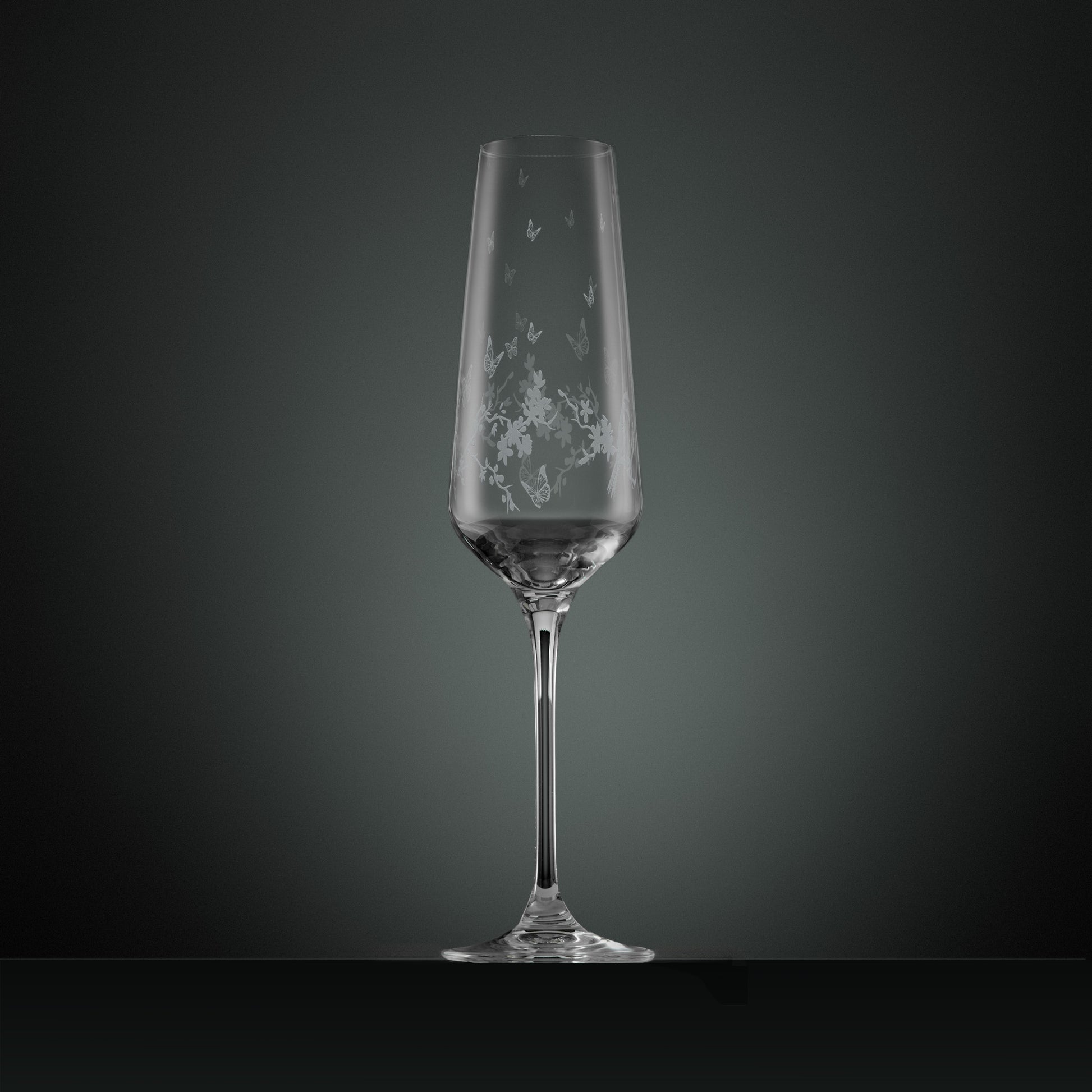 Engraved wraparound garland featuring garden birds, butterflies and blossom on a champagne flute