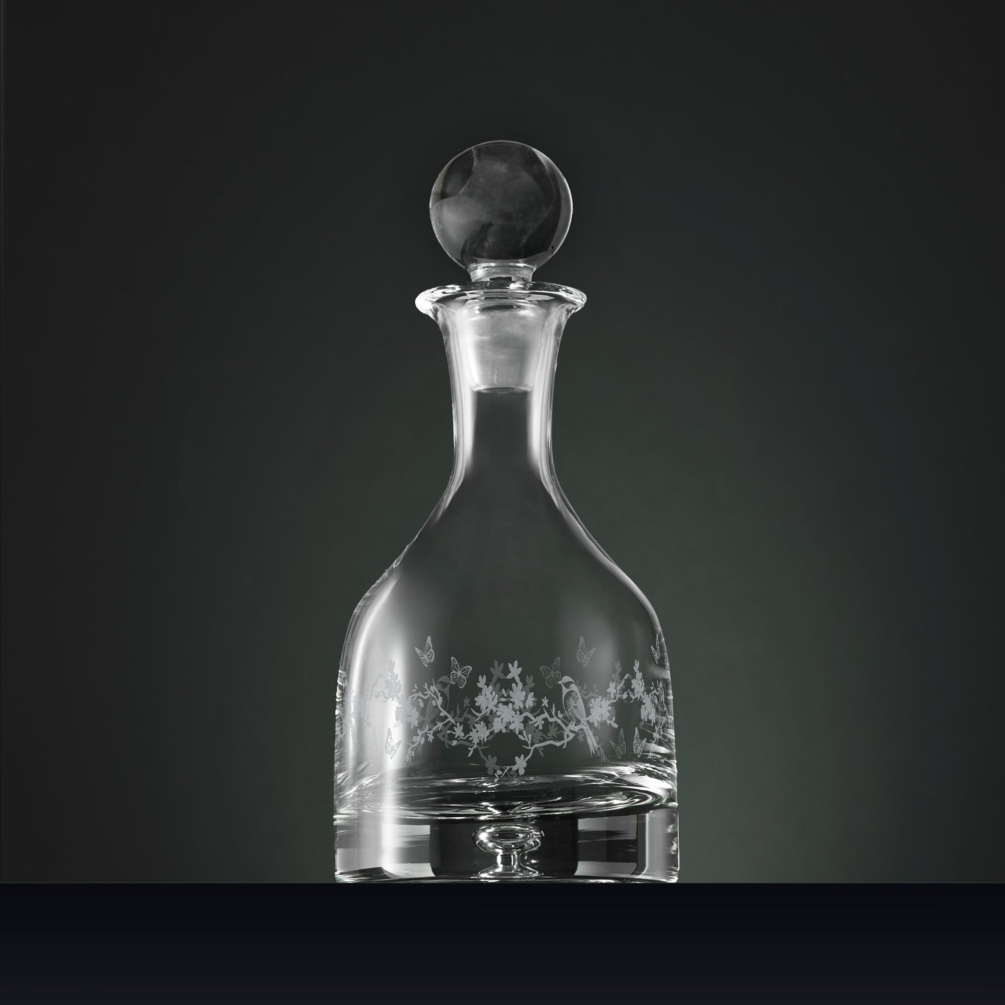 Handmade wine decanter featuring engraved garden birds, blossom and butterflies in a wraparound design