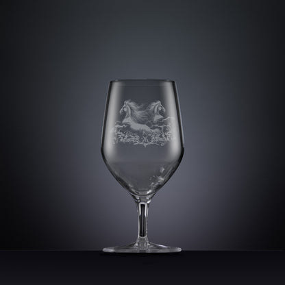 Engraved wine glass with an  illustration of two horses galloping through the water
