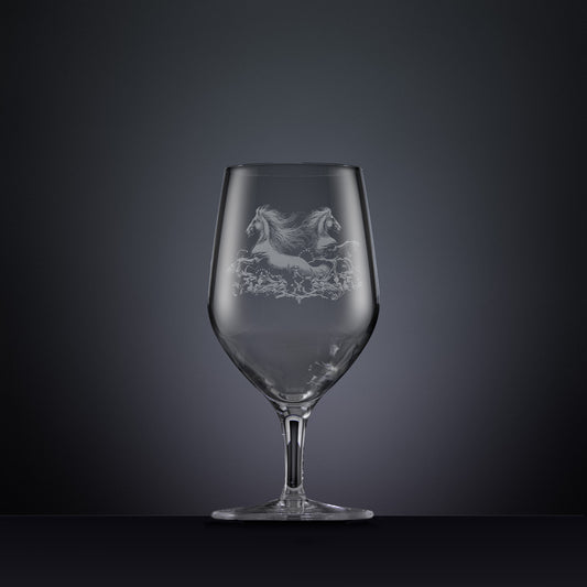 Engraved wine glass with an  illustration of two horses galloping through the water
