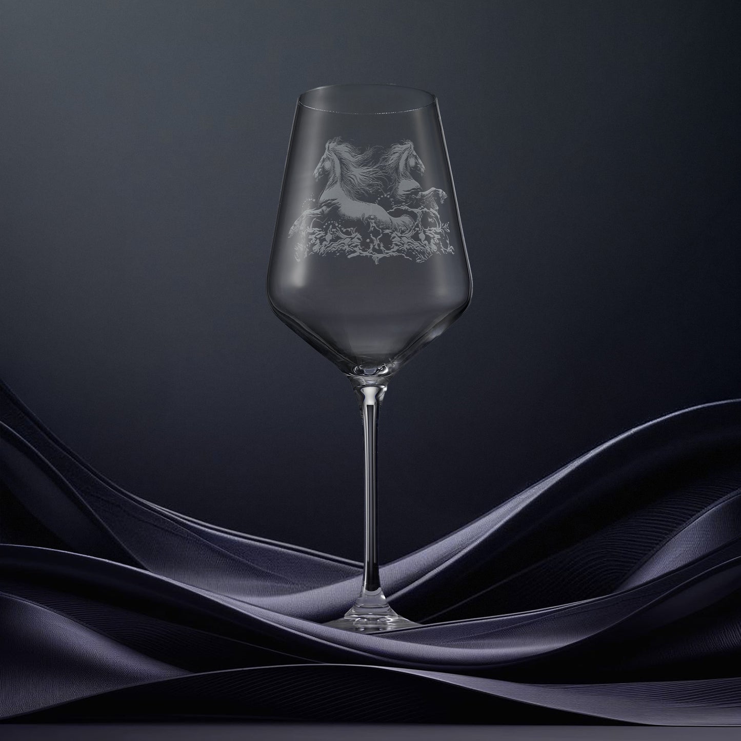 Engraved wine glass with an  illustration of two kelpies rising in the water