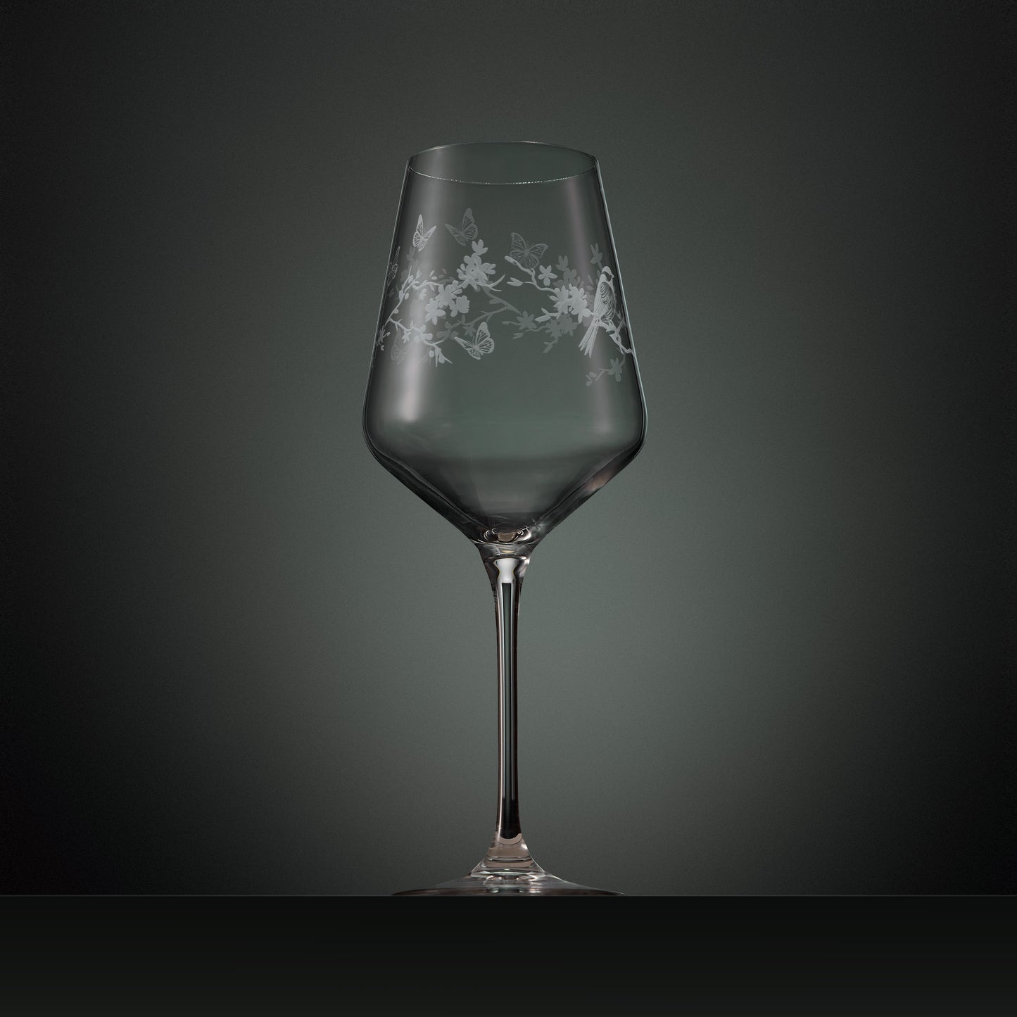 Hand engraved wine glass with floral, birds and butterflies illustration