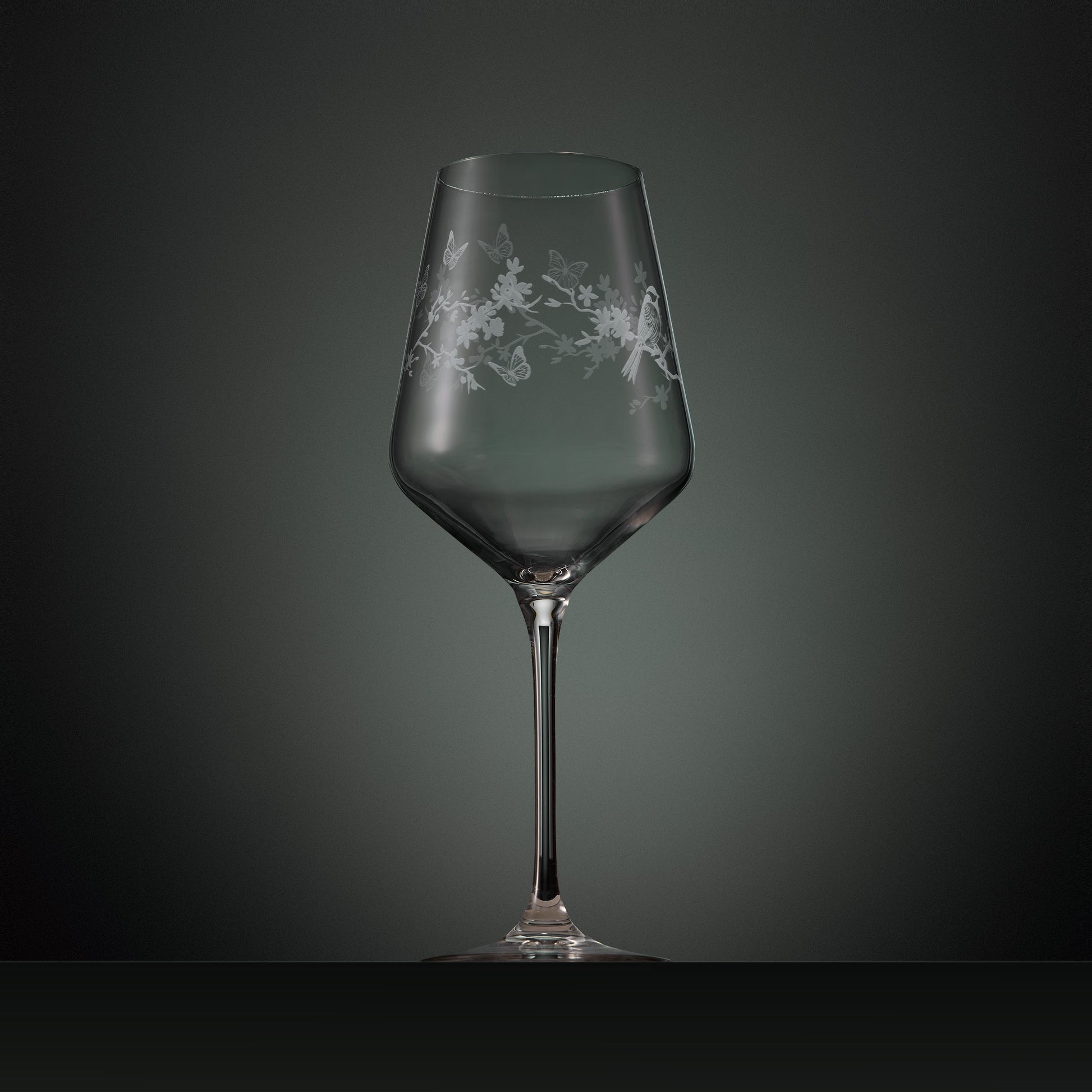Hand engraved wine glass with floral, birds and butterflies illustration