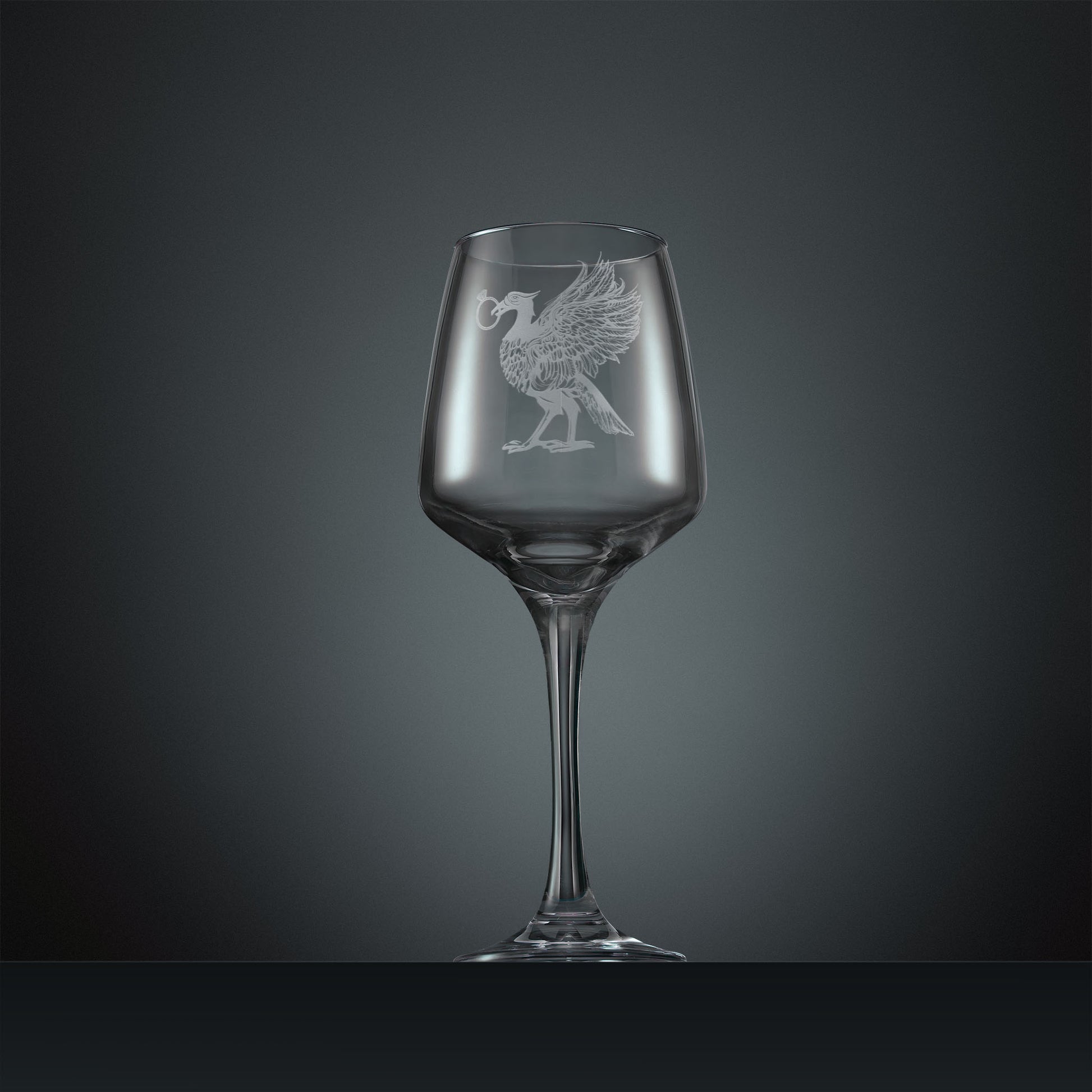 Engraved wine glass featuring a Liver Bird with an engagement ring in its beak