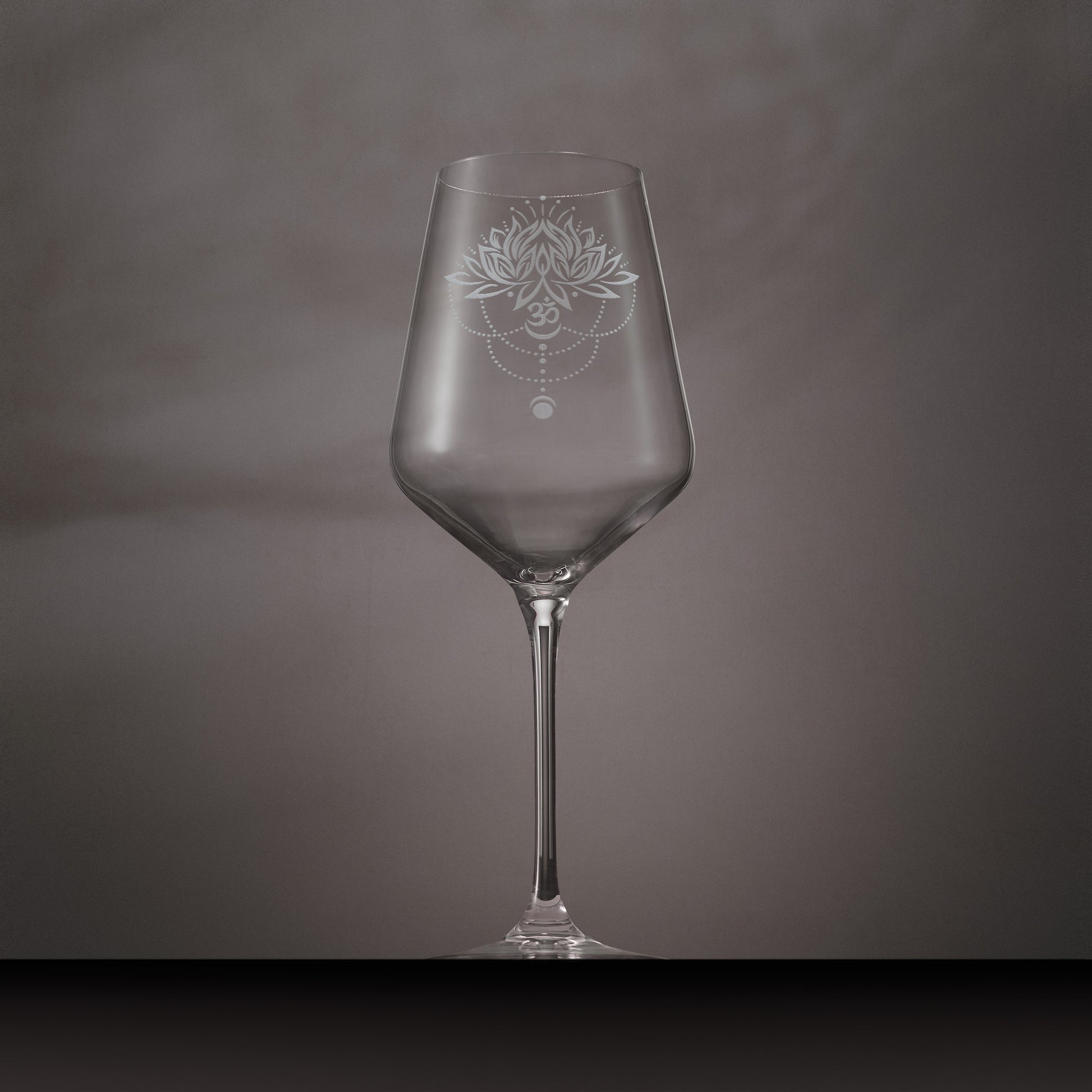 Wine glass engraved with lotus flower, water droplets om and lunar phase symbols