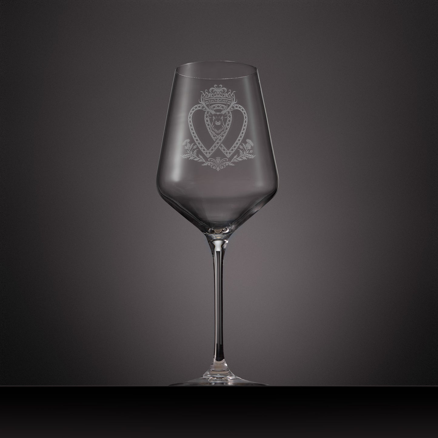 Engraved wine glass featuring a Scottish Luckenbooth and stags head design