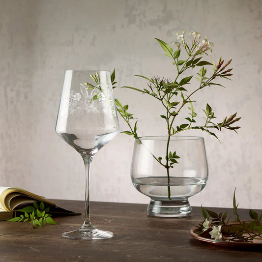 Engraved wine glass featuring daffodils, cherry blossom and a Hare in a wraparound design