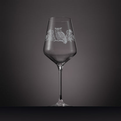 Engraved wine glass featuring marigolds, cosmos and a tawny owl