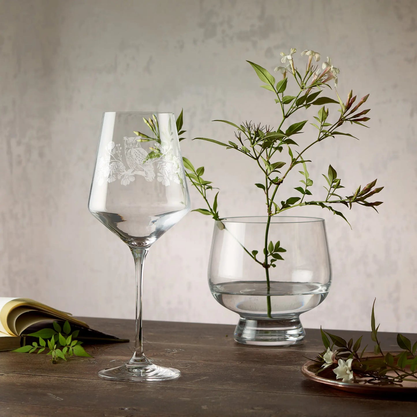 Engraved wine glass featuring marigolds, cosmos and a tawny owl in a wraparound composition