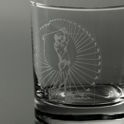 Engraved whisky glass featuring a golfer mid swing inside a circular pattern og golf clubs