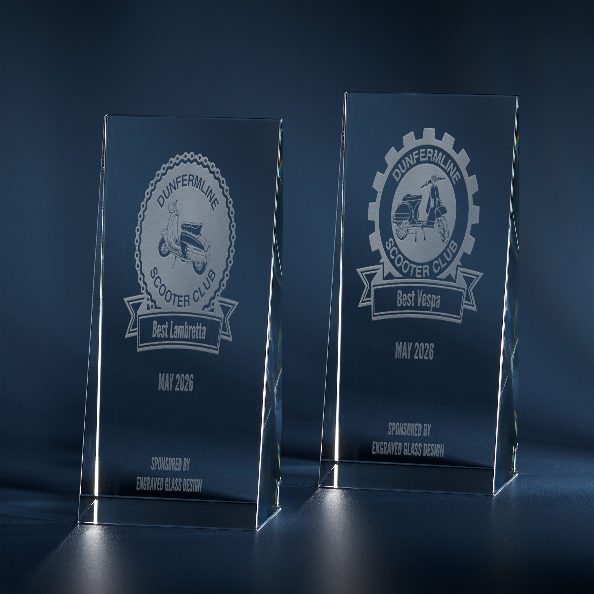 Two engraved scooter awards with personalised text, Vespa cogs and Lambretta chains