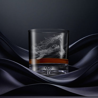 Engraved whisky glass with an  illustration of a selkie emerging from the water